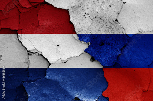 flags of Netherlands and Russia painted on cracked wall