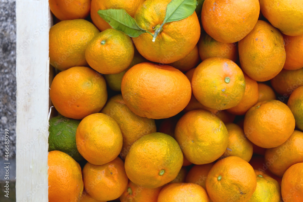 Wooden crate filled with fresh tangerines. Top view. Wooden crate filled with fresh tangerines. Top view.
