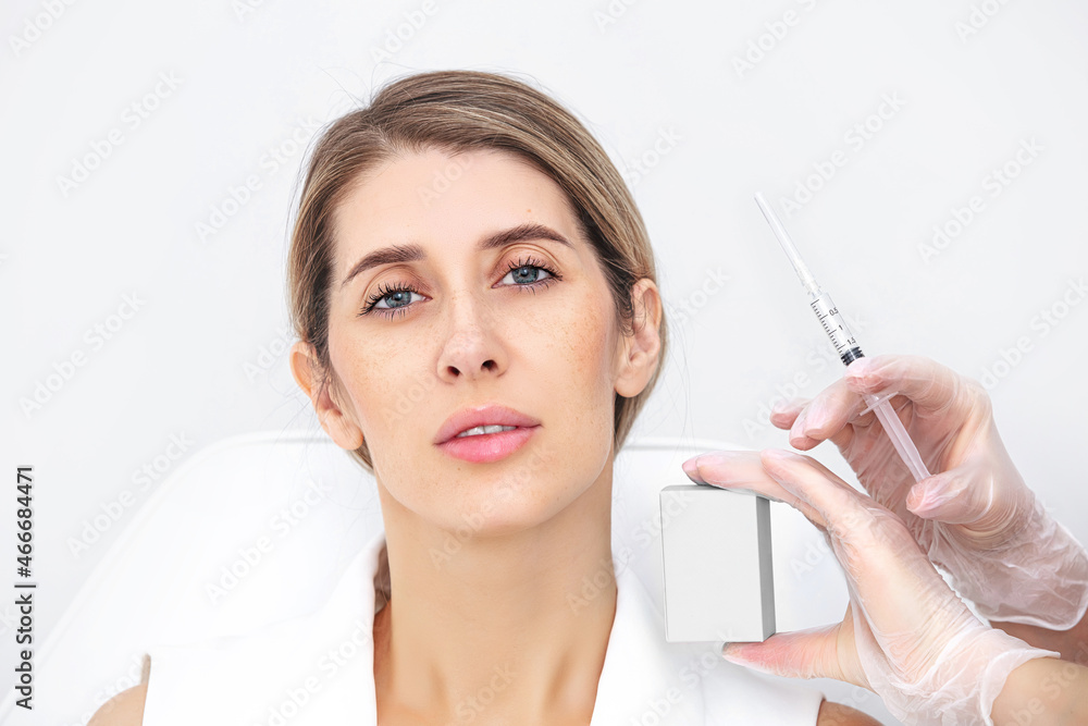 Skin lifting injection. Woman receiving beauty injection over white background. Studio shot.