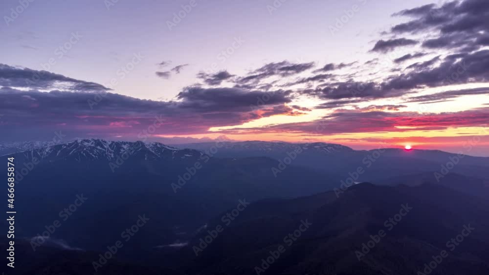 Timelapse of sunset over Fagaras mountains national park from Piatra Craiului national park in Romania Timelapse of sunset over Fagaras mountains national park from Piatra Craiului national park in Romania