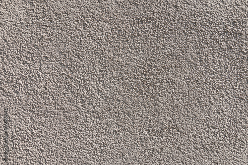 Gray concrete wall texture and background. Gray cement, grit, plaster. Corrugated, rough surface.