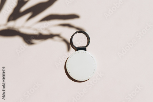 Keychain mockup with tree shadow to display design. Blank white sublimation key chain photo.