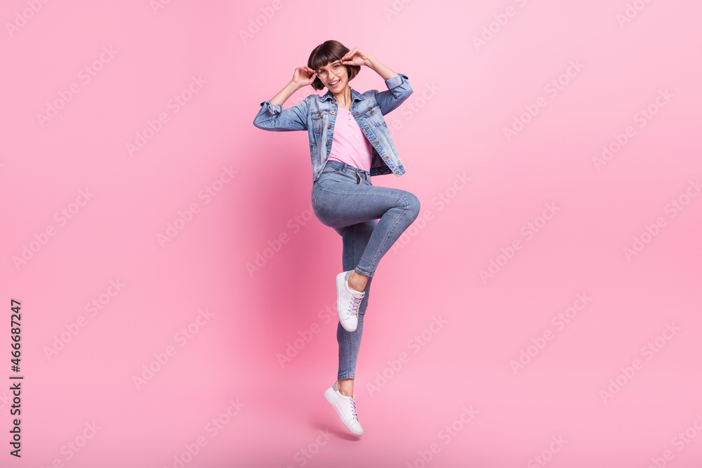 Full length body size view of attractive cheerful thin girl jumping posing isolated over pink pastel color background
