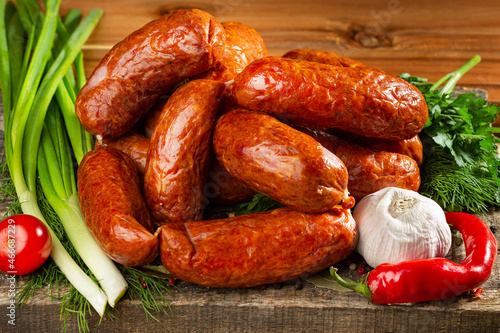 Pork sausages lying on a cutting board. Front view.