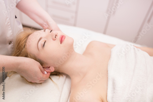Beautician makes facial massage girl. Lymphatic drainage massage LPG, apparatus process. Beauty treatments at the beauty salon SPA. Liquefied gas and contour treatment of the face and body. Skin care.