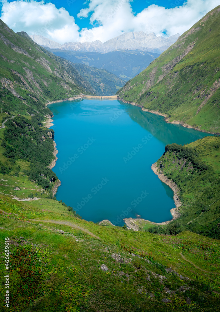 Beautiful and clean, vivid blue color water reservoir in the Austrian Alps