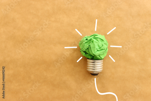 Concept image of green crumpled paper lightbulb, symbol of scr, innovation and eco friendly business