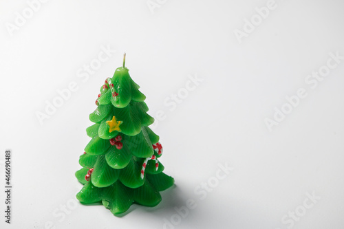 Christmas tree green decorative candle isolated on white background