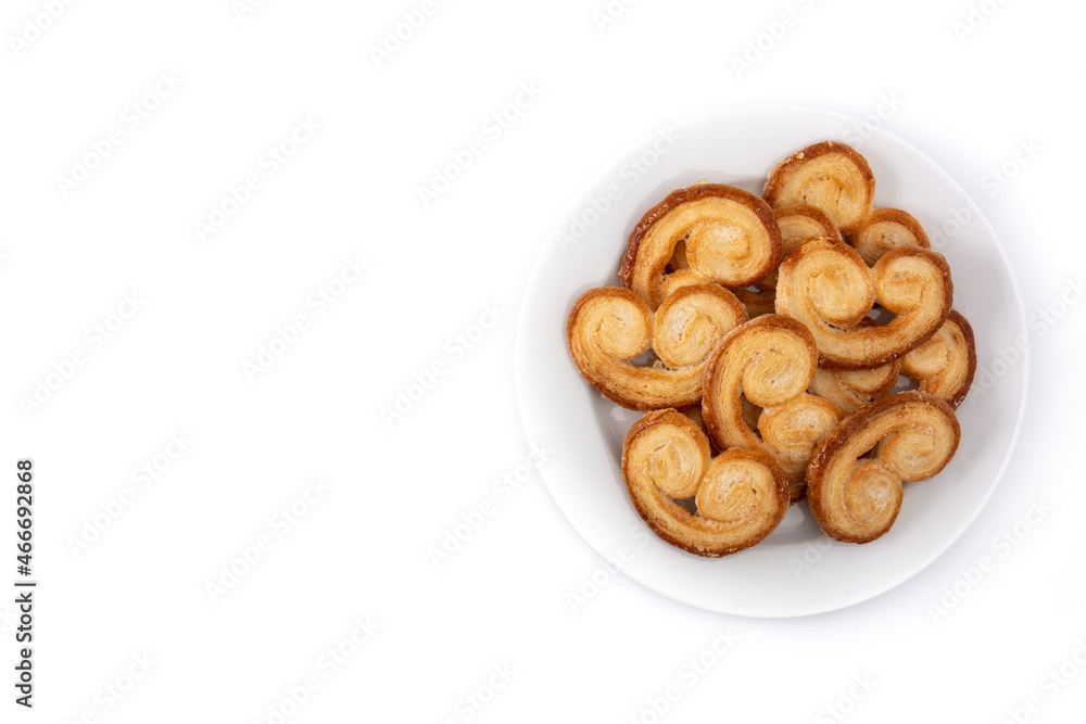 Palmier puff pastry in plate isolated on white background. Top view. Copy space