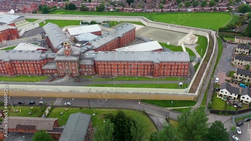 Aerial drone footage of the town centre of Wakefield in West Yorkshire in the UK showing the main building and walls of Her Majesty's Prison, also know as HMP Wakefield taken in the summer time photo