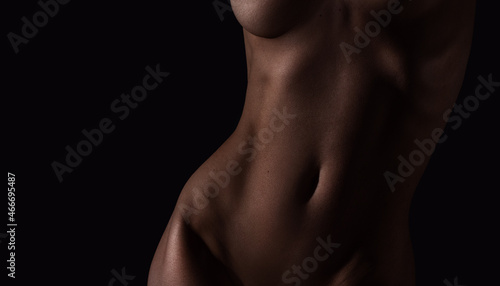 Beautiful lines of the female body on a dark background