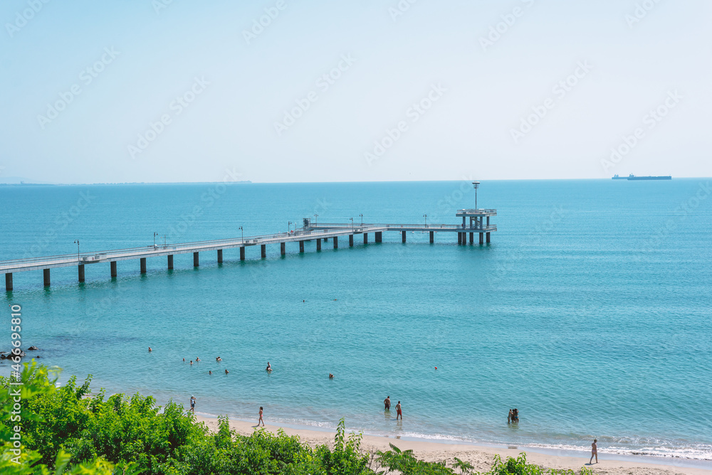 Beach, coast in Bulgaria. View of the sea and pier on a sunny day.