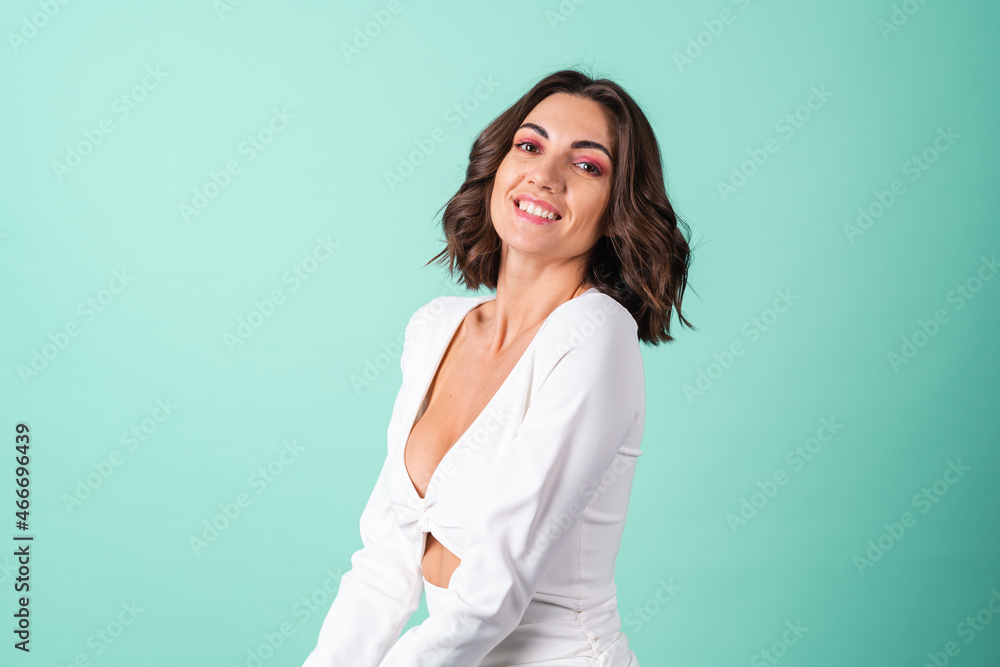 Young woman in a white evening dress on a light green background with bright pink makeup Young woman in a white evening dress on a light green background with bright pink makeup