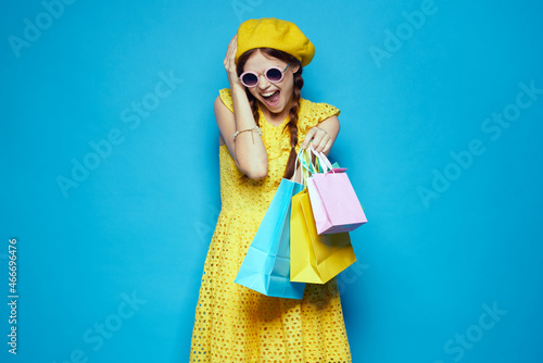 glamorous woman with multicolored bags posing isolated background