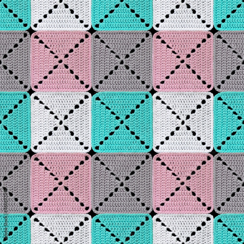 Seamless knitted pattern in patchwork style. The geometric elements are crocheted from multi-colored acrylic yarn. Pastel colors.