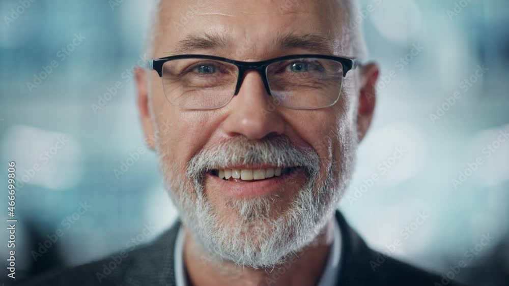 Portrait of Successful Middle Aged Bearded Man Looking at Camera and Smiling. Handsome Senior Businessman Wearing Jacket Rising Eyes, Having Fun. Close-up Shot Portrait of Successful Middle Aged Bearded Man Looking at Camera and Smiling. Handsome Senior Businessman Wearing Jacket Rising Eyes, Having Fun. Close-up Shot