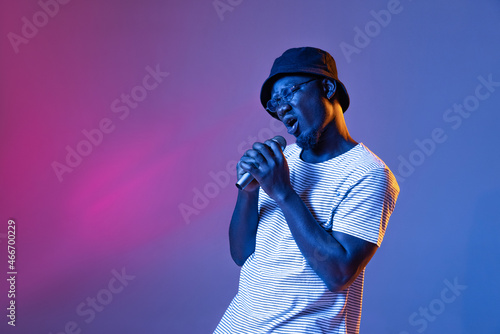 Canvas Print Studio shot of emotive african man with microphone isolated over gradient purple