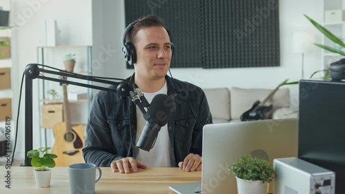 Content Creator, Social Media Influencer Hosts a Podcast While Working at the Computer and Interacting With the Audience in a Professional Studio. Concept of Online Meetings and Podcasts