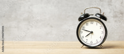 Vintage alarm clock on wooden table background and copy space for text. Activity, daily routine, morning, workout and Work life balance concept