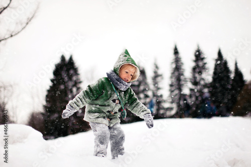 Little Girl in Winter Coat Climbing the Snow Hill