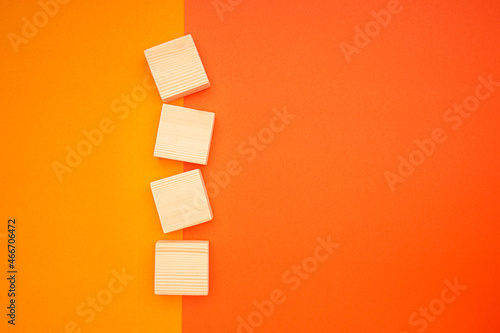 Blank four wooden cubes on colorful background with space for text