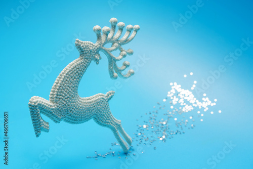 A toy deer galloping along a sparkling path. © Алексей Коза
