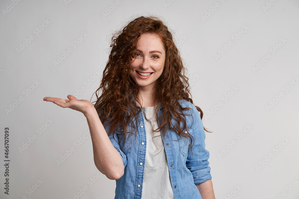 Smiling adult woman showing at empty copy space Smiling adult woman showing at empty copy space
