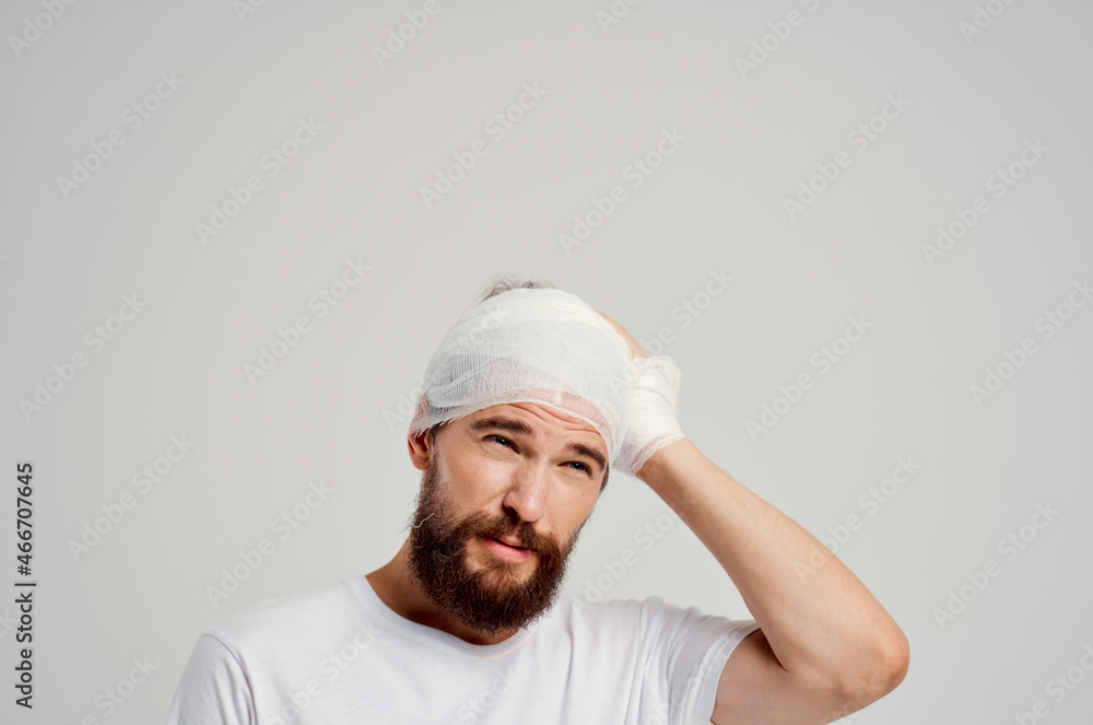 Man head and arm injuries health problems light background Man head and arm injuries health problems light background