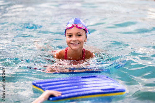 Portrait of little smiling girl in swimming pool © Olena Shvets