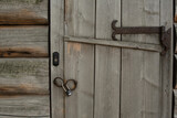 The door of wooden house with modern doorbell or intercom. Contrast concept