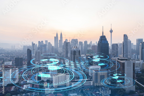 Canvas Print Glowing hologram of technological process, aerial panoramic cityscape of Kuala Lumpur at sunset