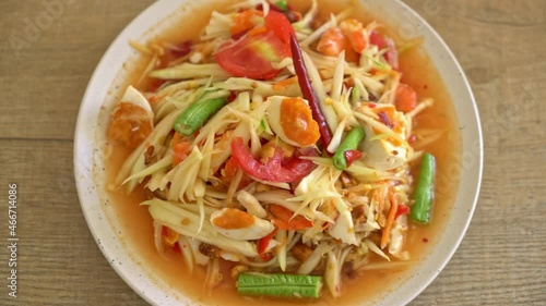 Som Tum - Thai Spicy green papaya salad with salty eggs - Asian food style photo