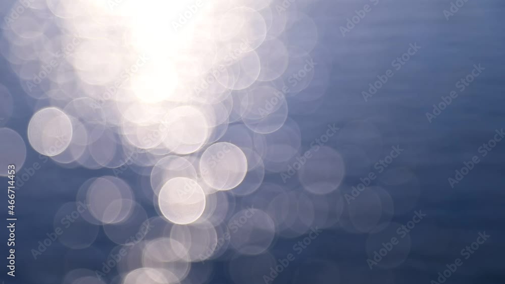 Abstract motion of the sunrise sea, shimmering water defocused background, bokeh effect Abstract motion of the sunrise sea, shimmering water defocused background, bokeh effect