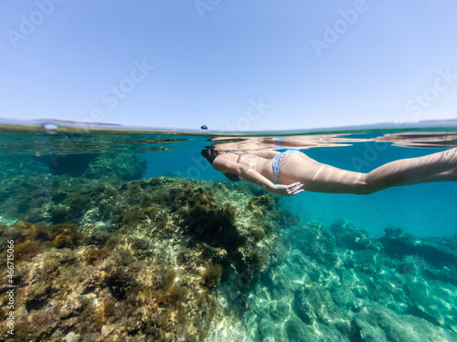 Half above and half below photo of girl snorkeling