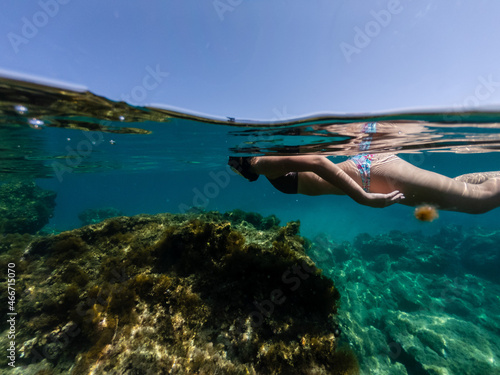 Half above and half below photo of girl snorkeling