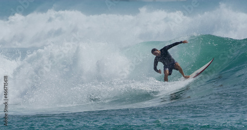 Surfer surfing tropical ocean wave attacking off the lip