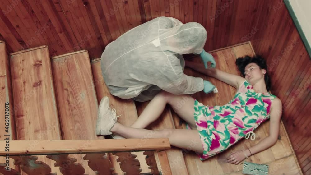 Crime scene investigator collecting evidence near dead girl on stairs