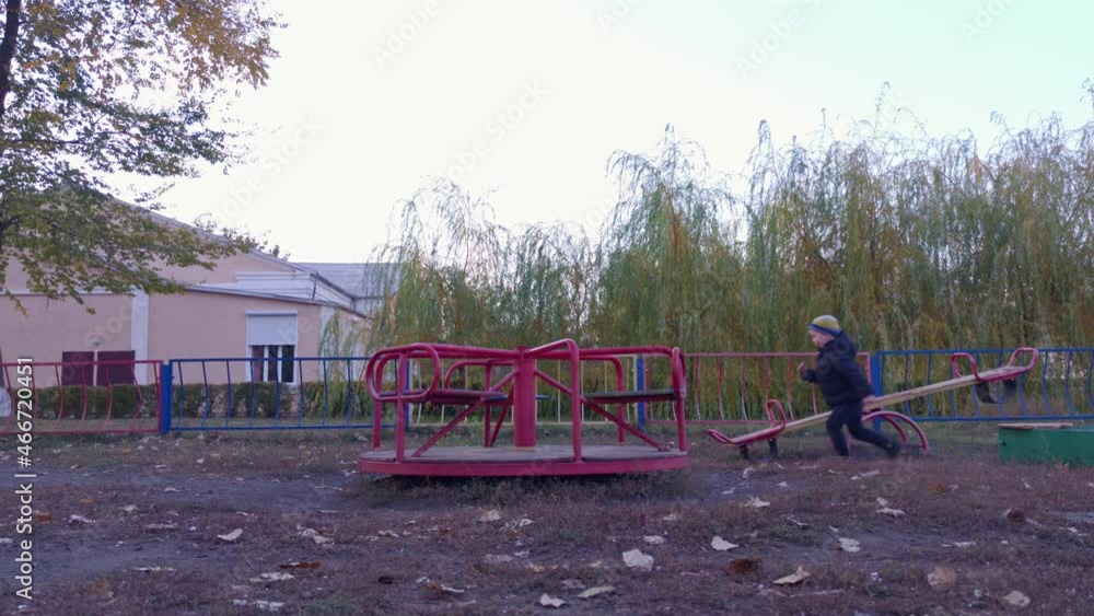 Boy on the playground slow motion autumn evening Boy on the playground slow motion autumn evening