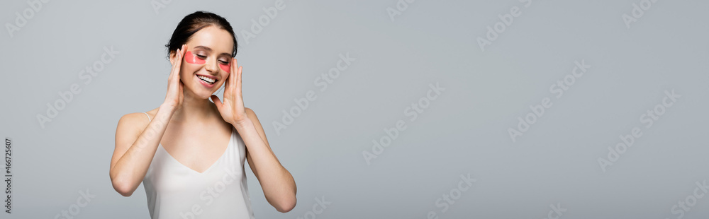 Smiling woman with eye patches and satin dress isolated on grey, banner Smiling woman with eye patches and satin dress isolated on grey, banner