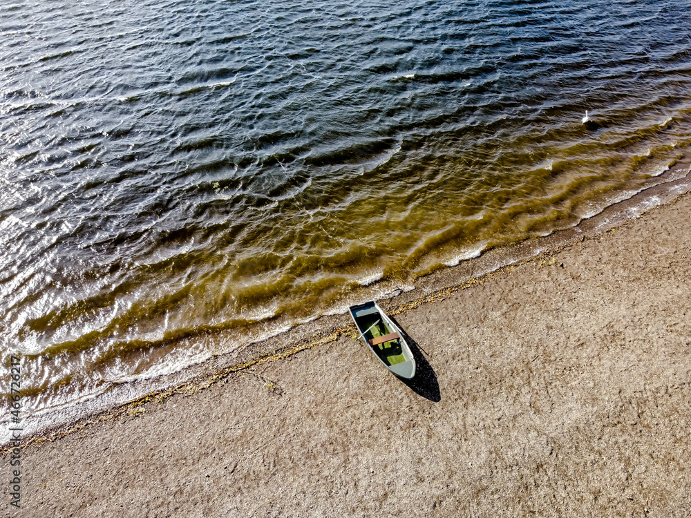 lonely boat on a beach background Stock Photo | Adobe Stock