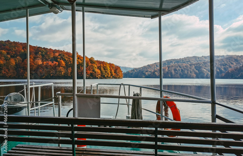 Empty tourist boat on beautiful lake in autumn photo