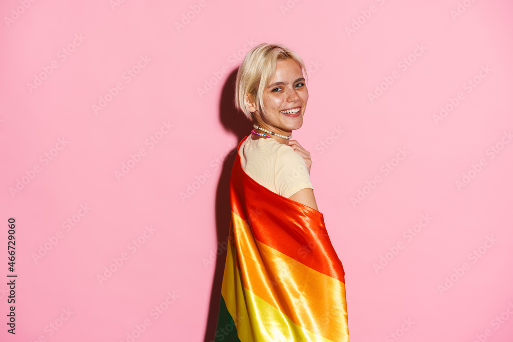 White woman laughing while posing with rainbow flag White woman laughing while posing with rainbow flag