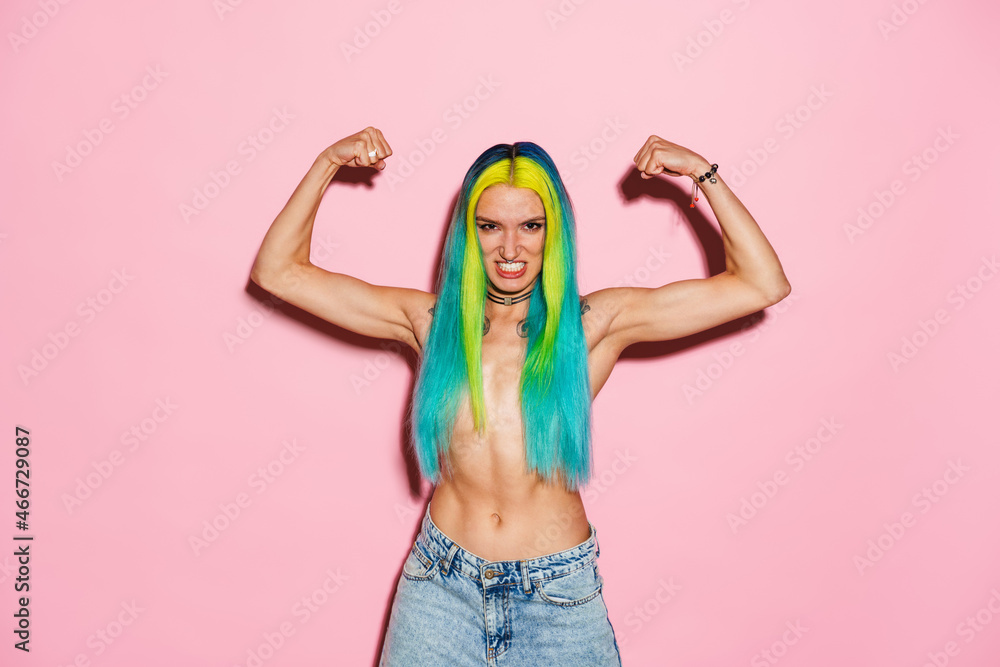 Shirtless woman with multicolored hair showing her biceps Shirtless woman with multicolored hair showing her biceps