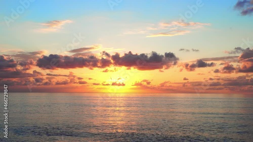shooting a majestic sunset or sunrise landscape on the sea on the horizon. Amazing natural landscape bright sky and receding clouds, rolling colorful bright orange clouds at sunset.