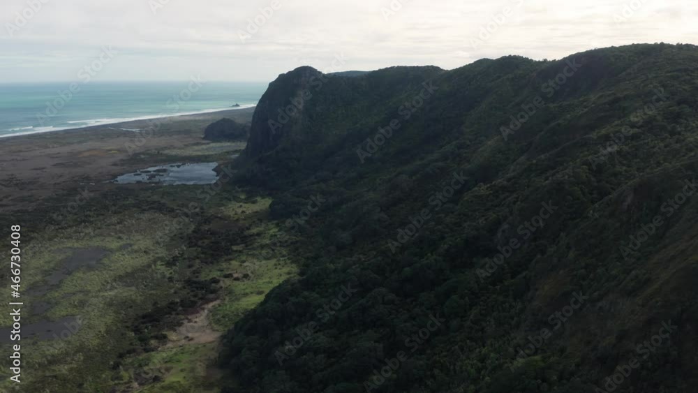 Aerial: Coastal Hills and wild ocean in the waitakere ranges. Whatipu, Auckland, New Zealand Aerial: Coastal Hills and wild ocean in the waitakere ranges. Whatipu, Auckland, New Zealand