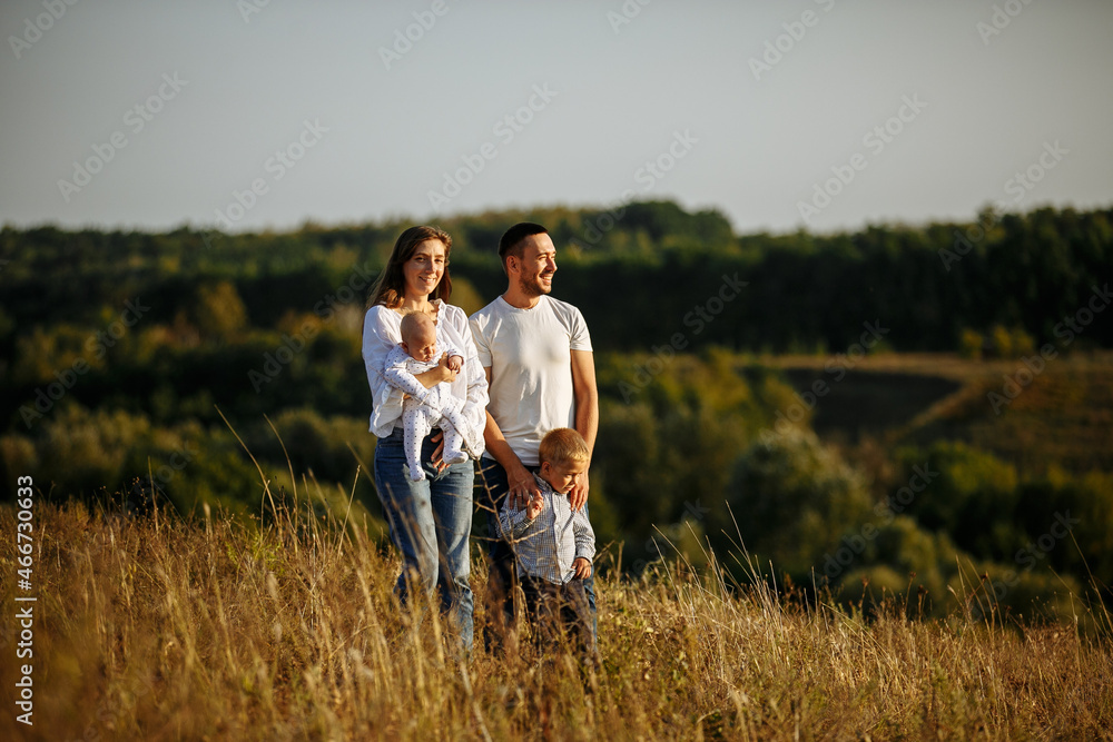 family in white t-shirts and blue jeans walking in nature