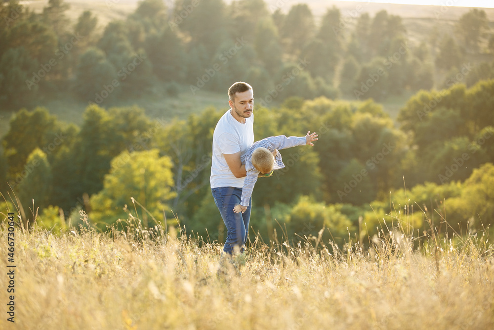 dad spinning with his son in his arms in nature dad spinning with his son in his arms in nature