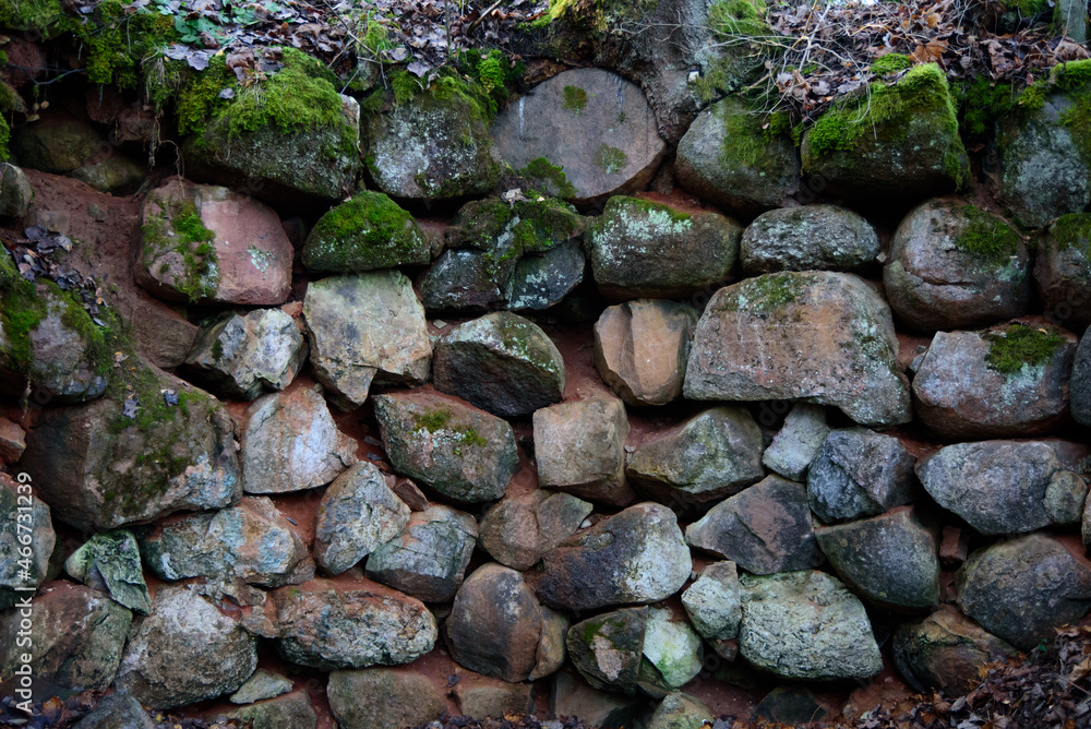 A beautiful stone wall in a nature park in the middle of the forest in autumn A beautiful stone wall in a nature park in the middle of the forest in autumn