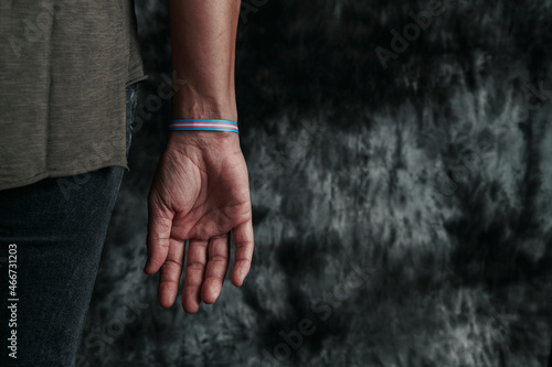 Fotografia is wearing a transgender pride wristband
