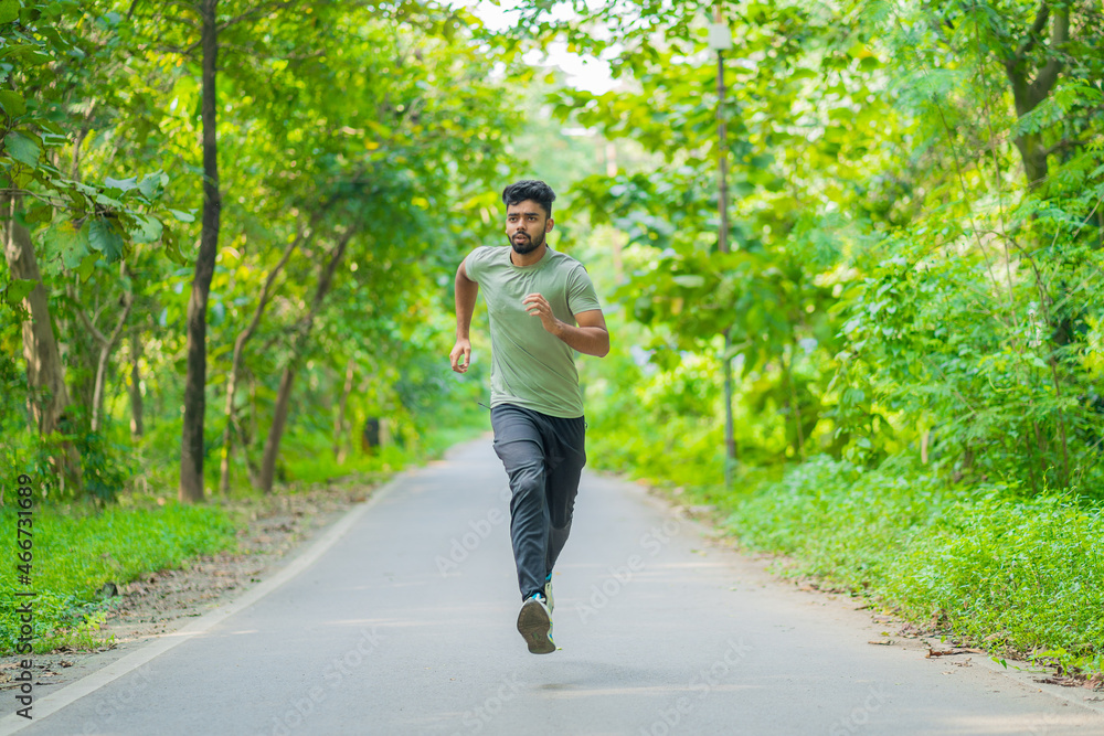 Young man running in the park at morning, also known as jogging or morning walk Young man running in the park at morning, also known as jogging or morning walk